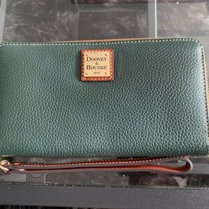 Brand new Dooney & Bourke wallet/wristlet Forrest green with red interior